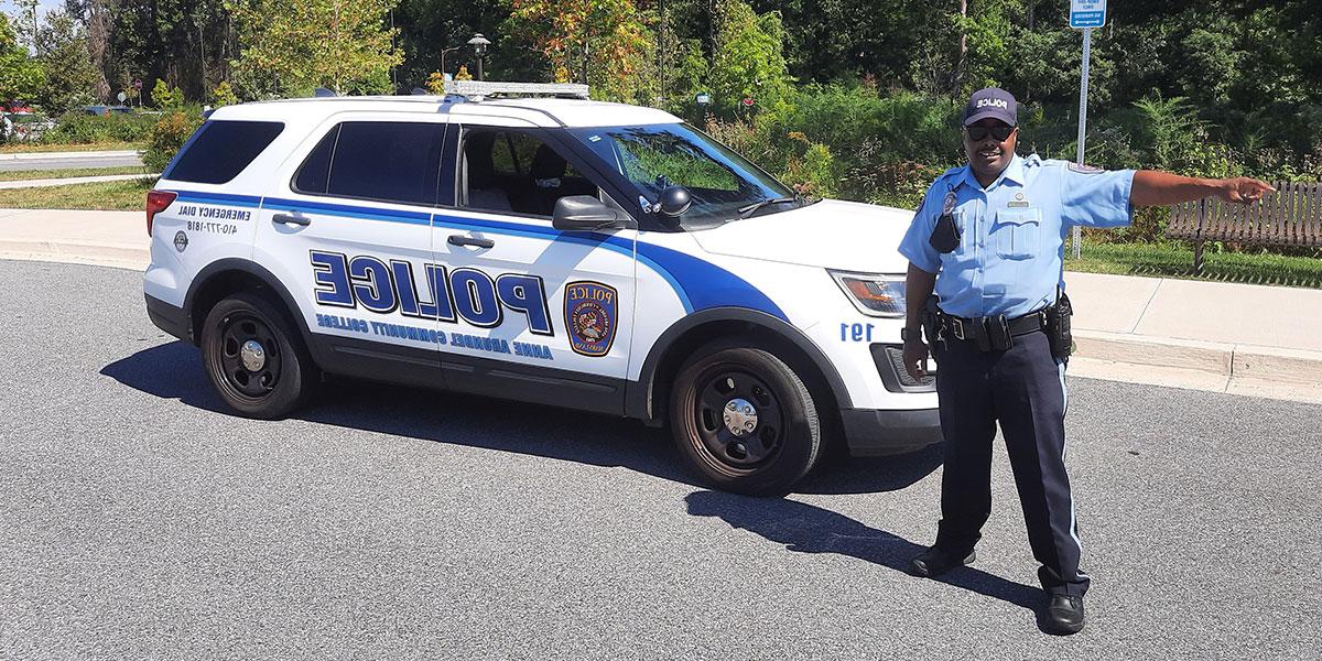 Department of Public Safety officer standing in front of patrol car